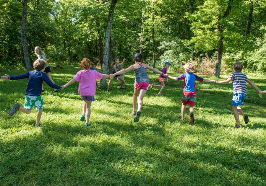 kids holding hands and playing outside