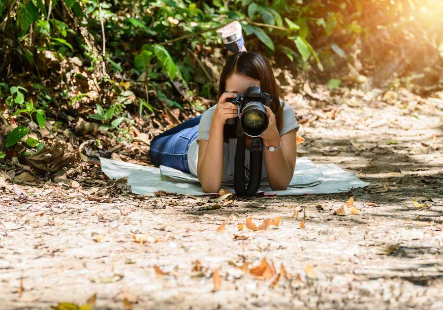 Girl using a camera outdoors