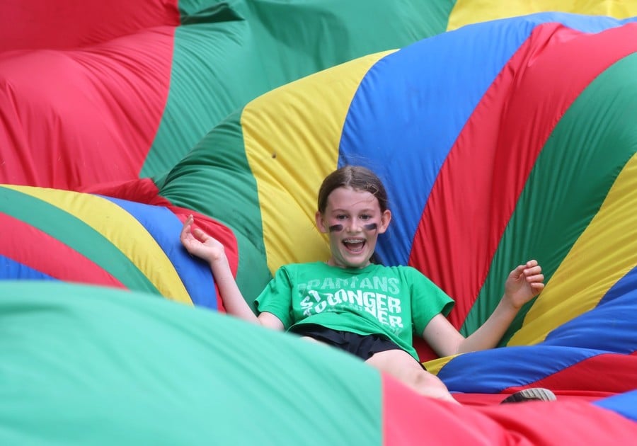 photo of female camper on parachute