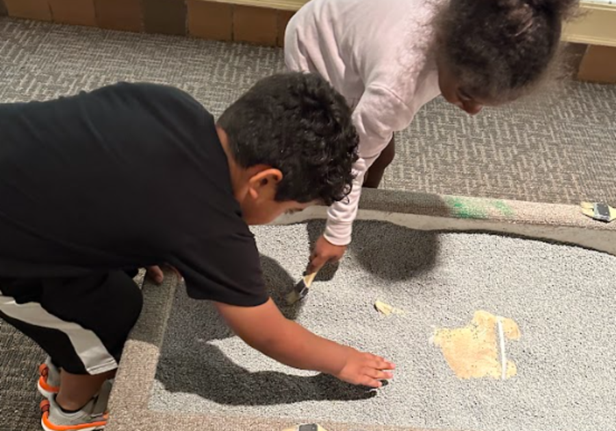 Children brushing off fossils