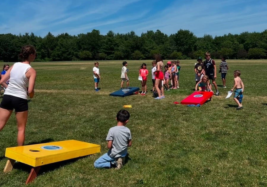 Kids playing cornhole