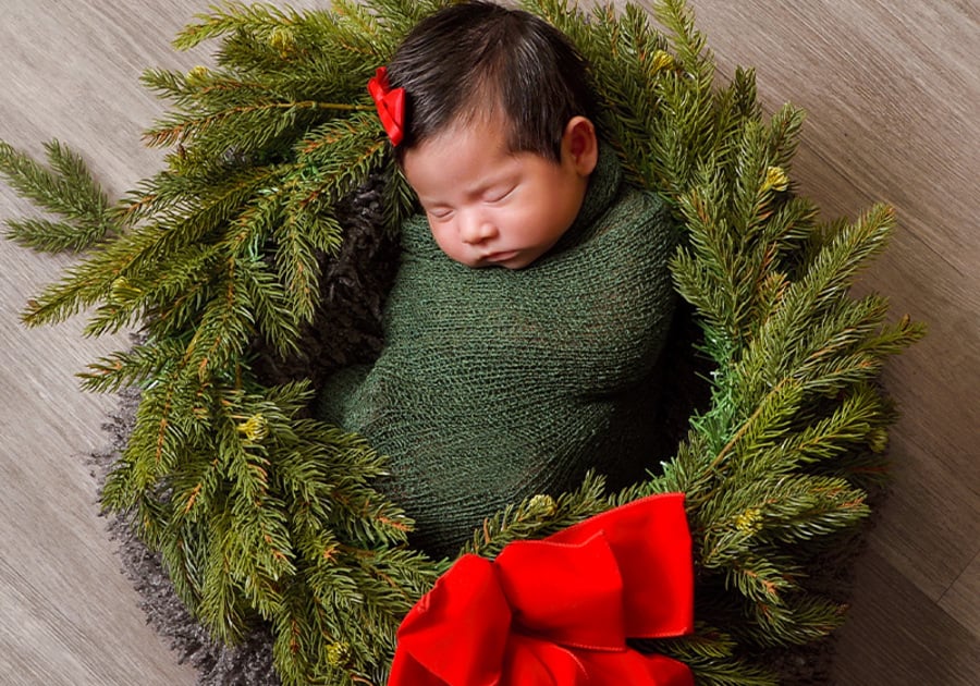 Newborn baby in holiday-themed setting, holiday photos at JCPenney Portraits