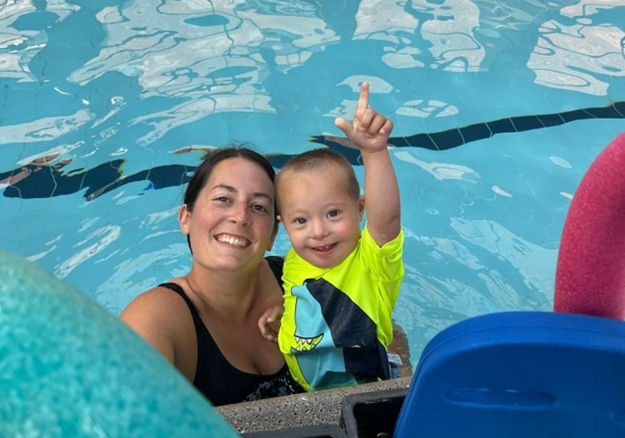 toddler in pool with woman