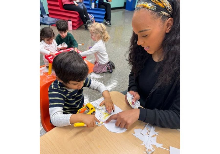 prek student working with teacher