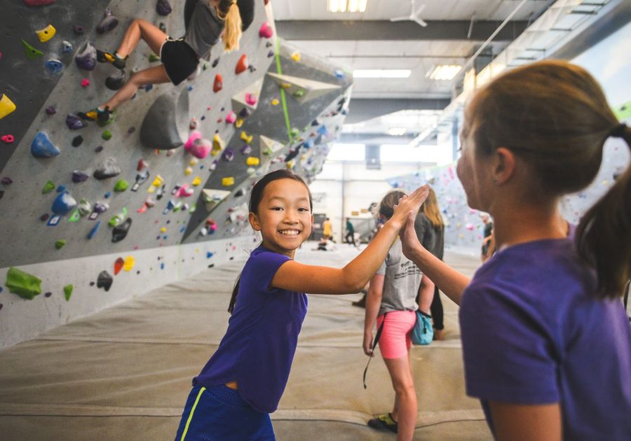 Girls climbing indoor rock wall