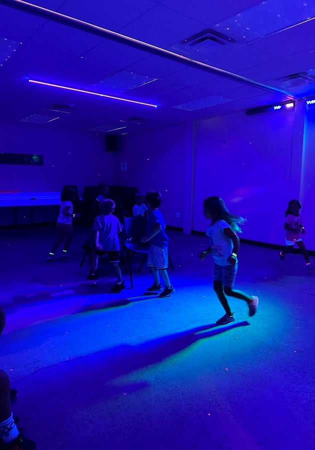 kids running in room with black light