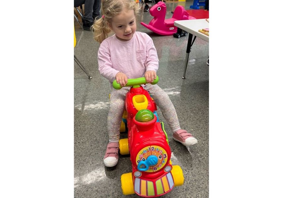 toddler girl on ride-along train