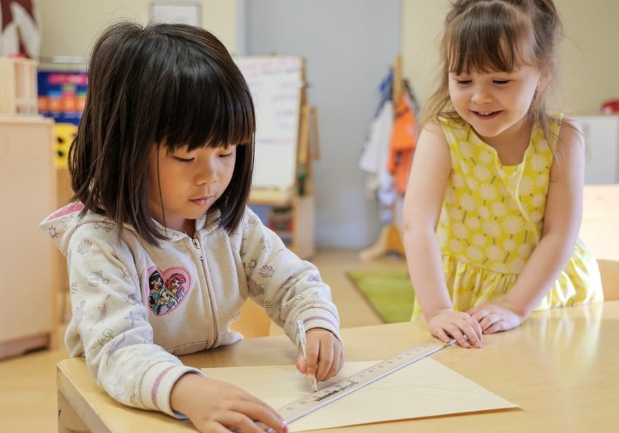 two prek girls drawing together