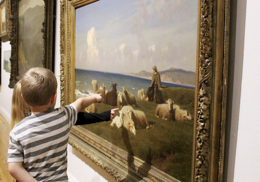 children in gallery at museum pointing out sheep in painting