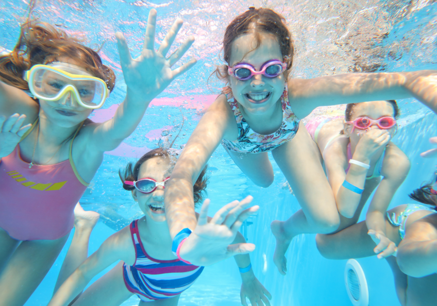 group of girls with goggles underwater