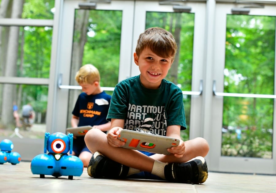 Benchmark Summer Camp boy sitting with ipad