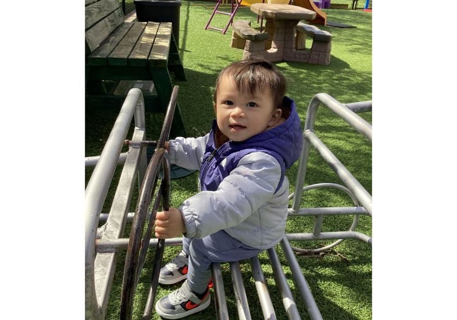 toddler on playground equipment