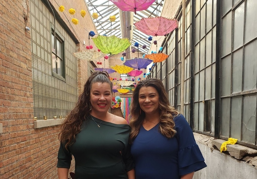 two women standing under colorful umbrellas