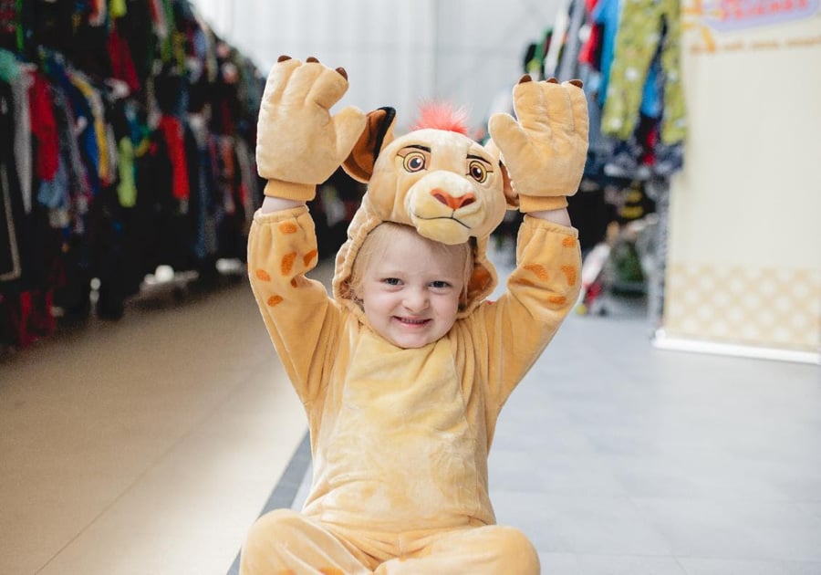 young child wearing a lion halloween costume