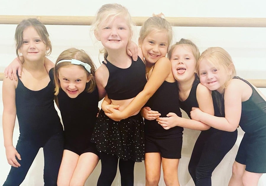 photo of young female dancers smiling for group photo