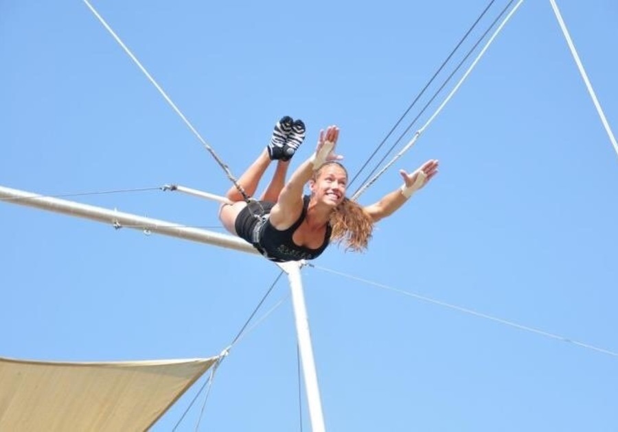 woman hanging from trapeze
