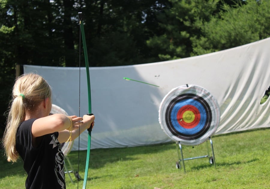 Girl shooting a bow and arrow
