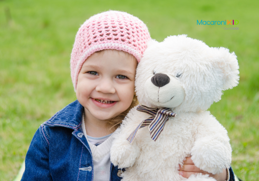 Girl hugging a teddy bear picnic