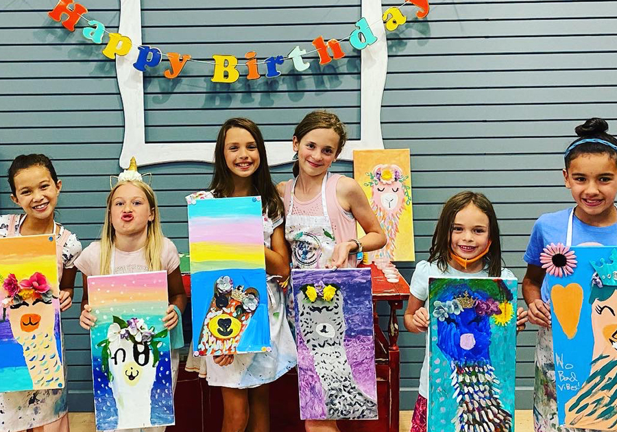 birthday party attendees showing off finished canvases at Createry Workshop