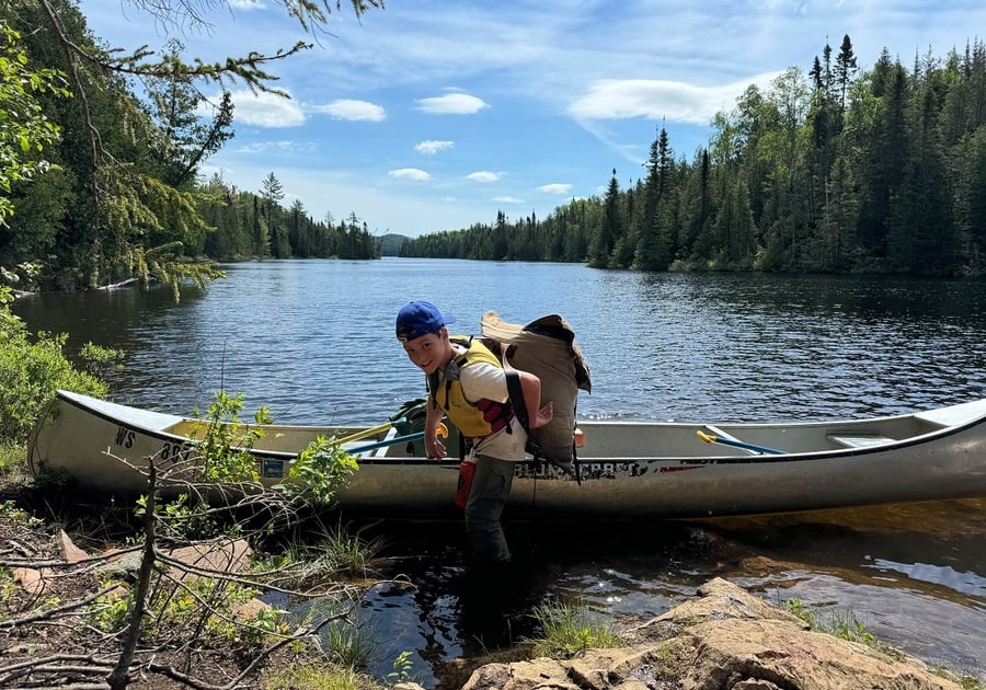 camper getting out of a canoe