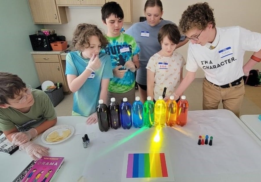 photo of campers doing water bottle rainbow experiment