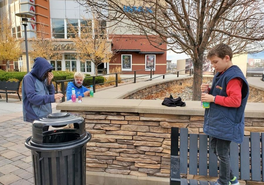 Sparks Marina Legends Shopping Center in front of theater father and two sons with candy things to do outdoors in sparks reno area kids family ideas outside