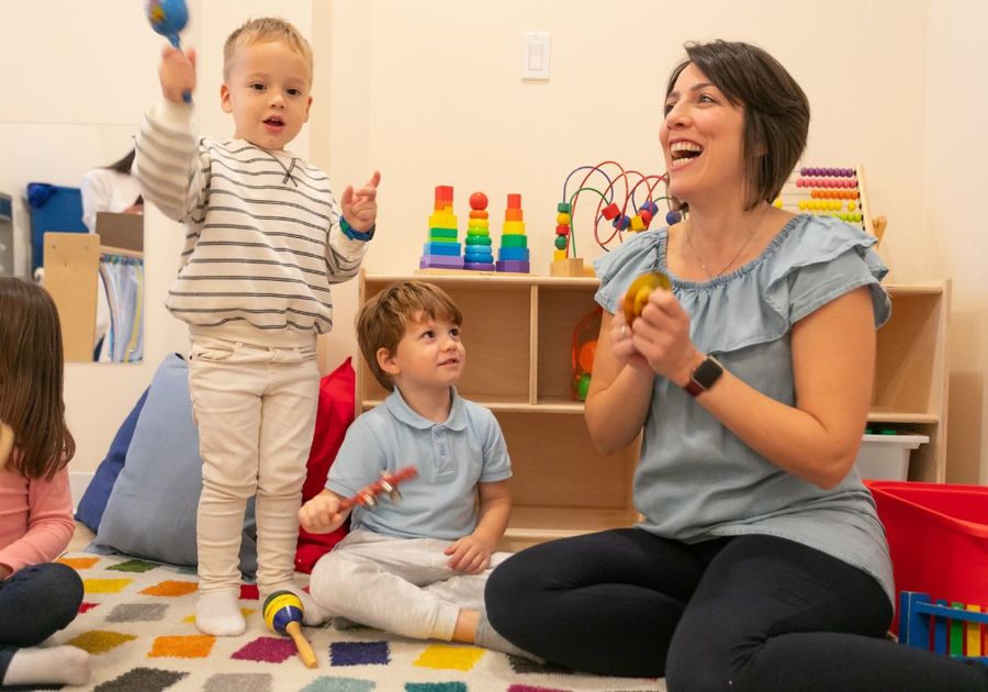 Woman playing music with two toddlers
