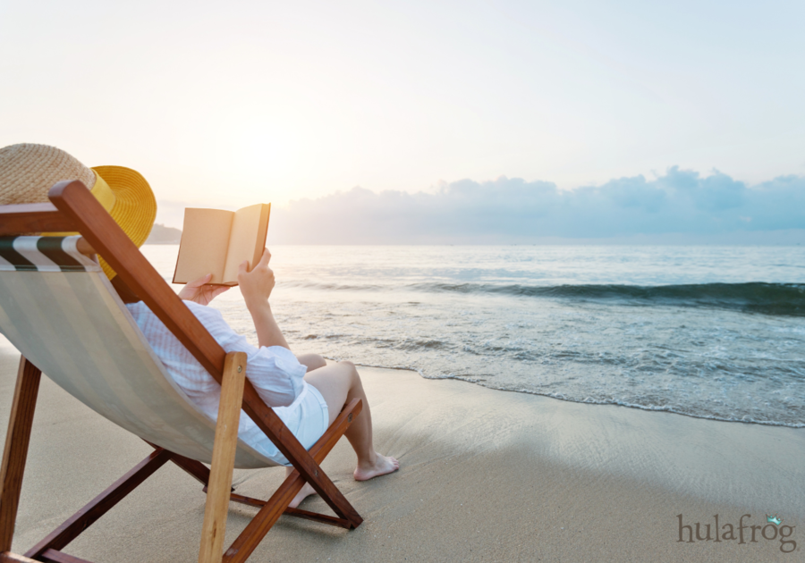 woman reading a book at the beach