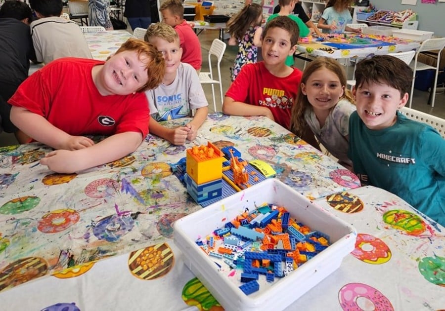 photo of campers posing with LEGO creation