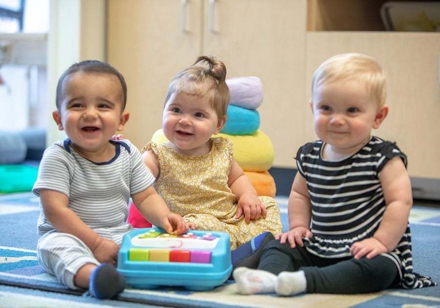 three babies smiling