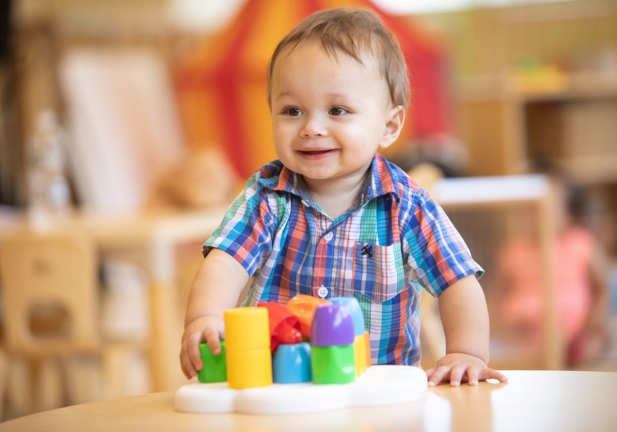 toddler boy playing with blocks