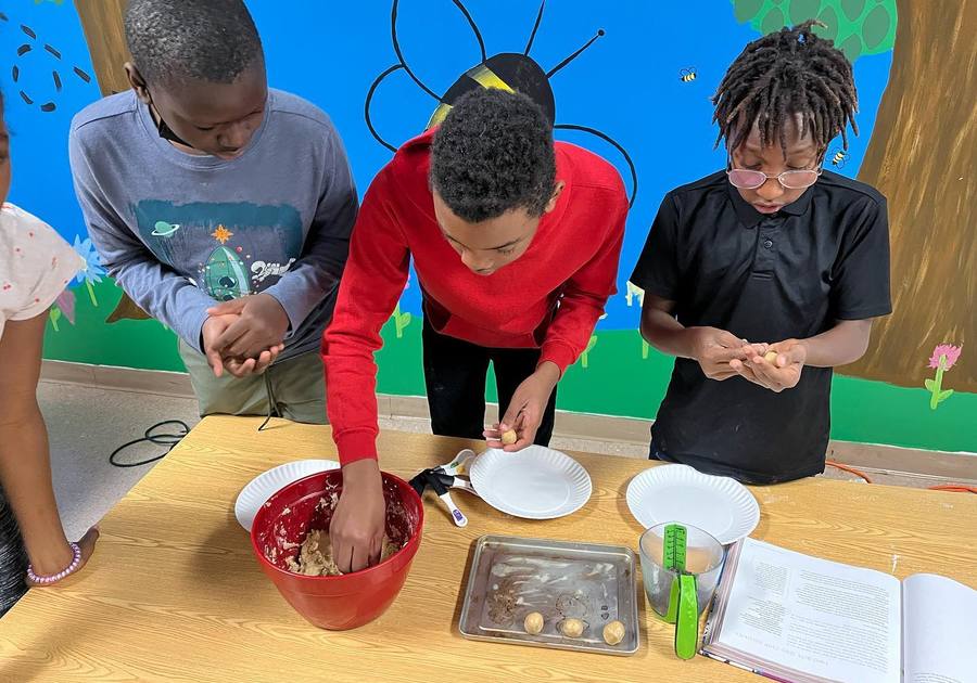 photo of young boys baking cookies