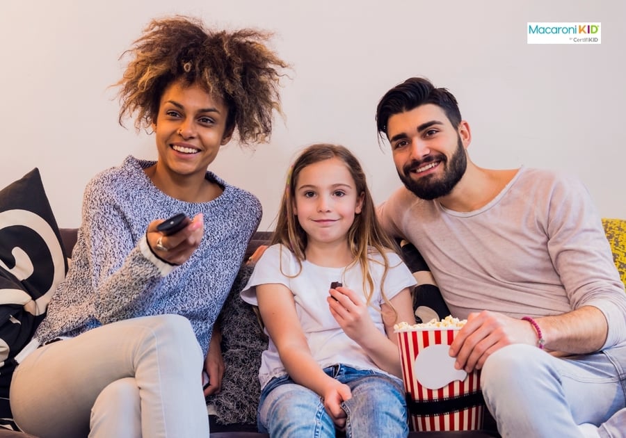 Family on couch with popcorn ready for movie night
