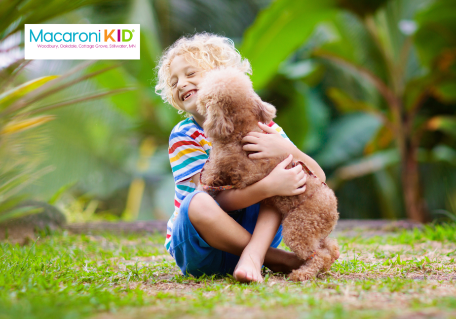 Child getting licked by puppy