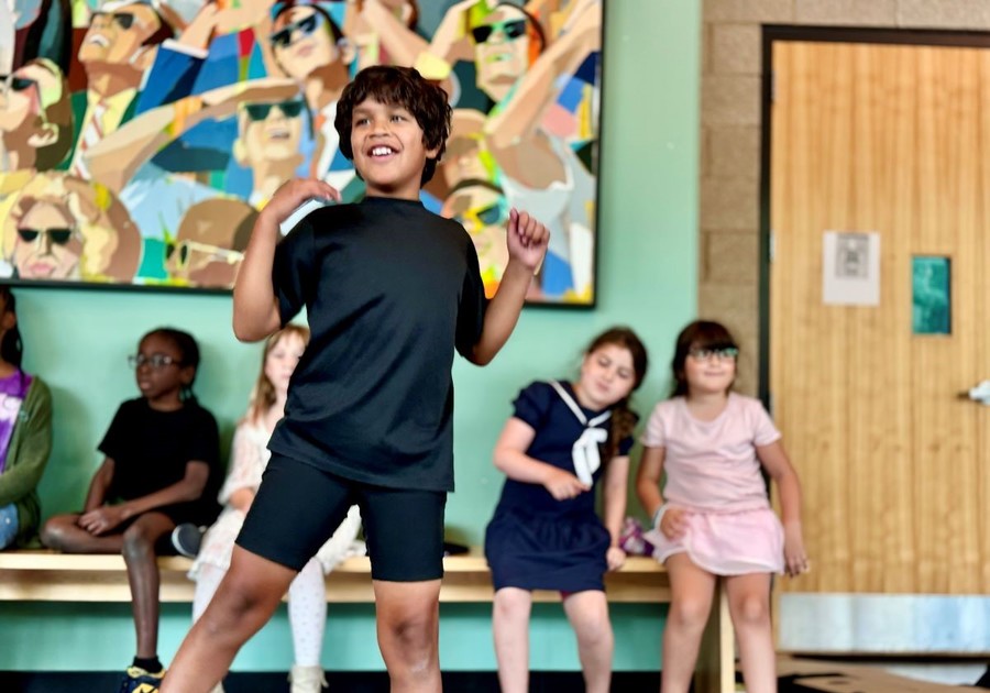 boy dancing in front of class