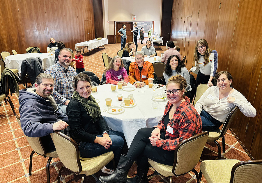 People smiling at a dining table