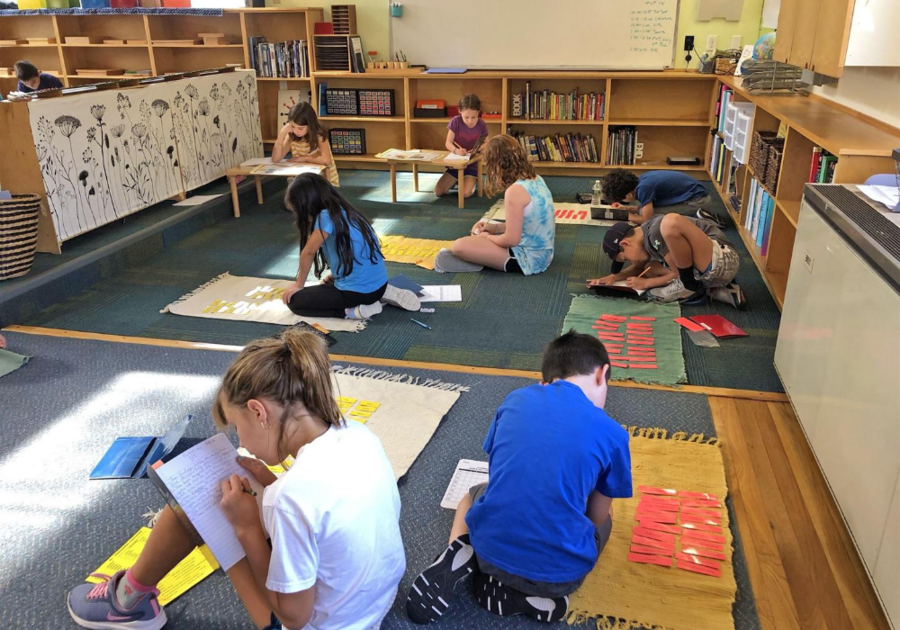 The Montessori classroom naturally provides the space for these Upper Elementary students to spread out to do their work.