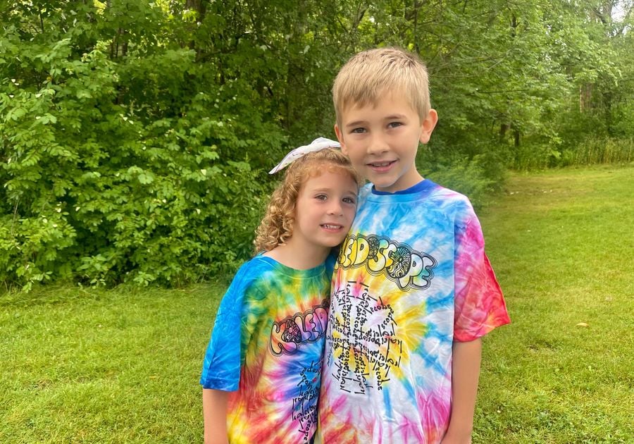 Two children outdoors in bright t-shirts