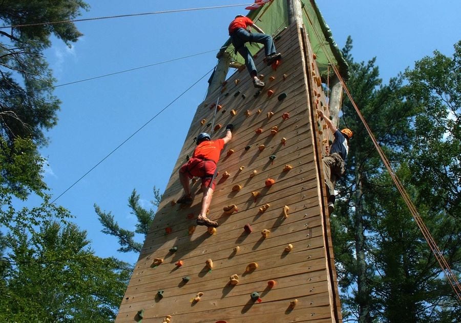 Campers climbing a climbing tower