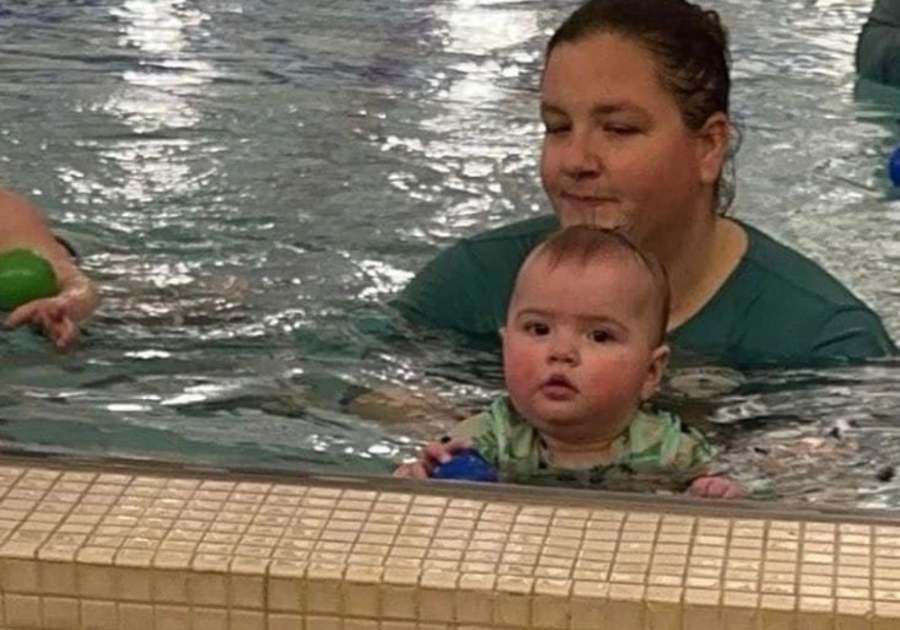 Woman and infant in pool