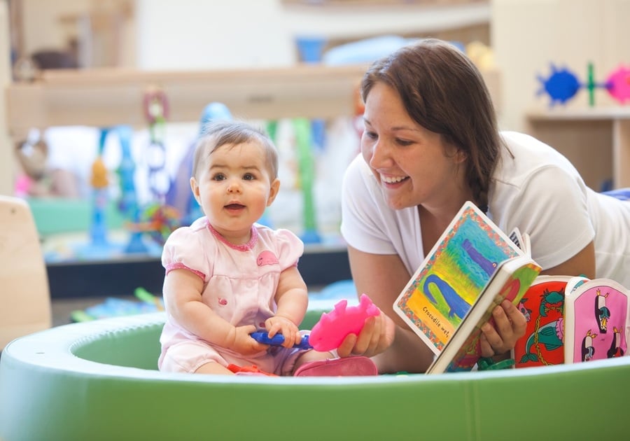 woman reading book to baby