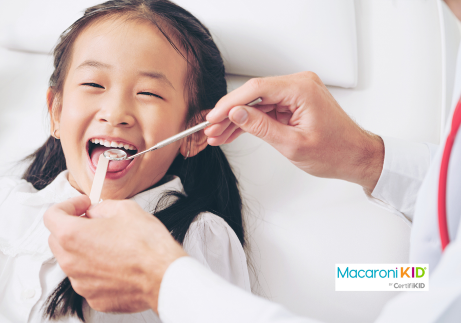 Dentist examining child teeth in dental clinic.