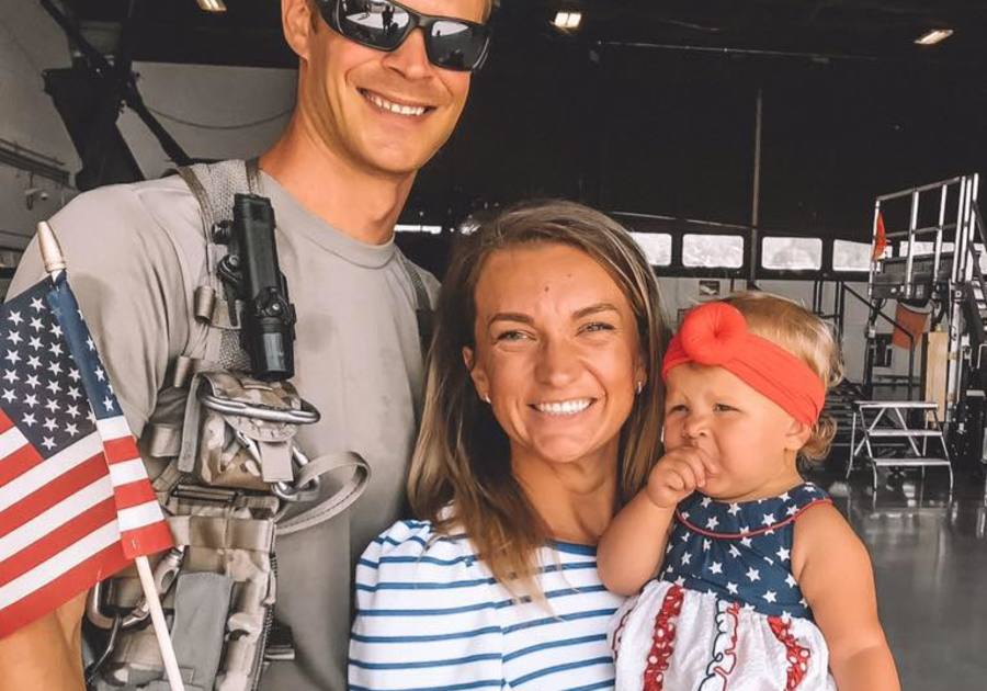 Publisher and family smiling at camera with american flag