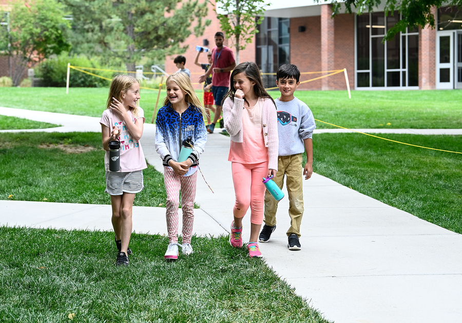 smiling kids walking together at Denver Academy Summer Camp