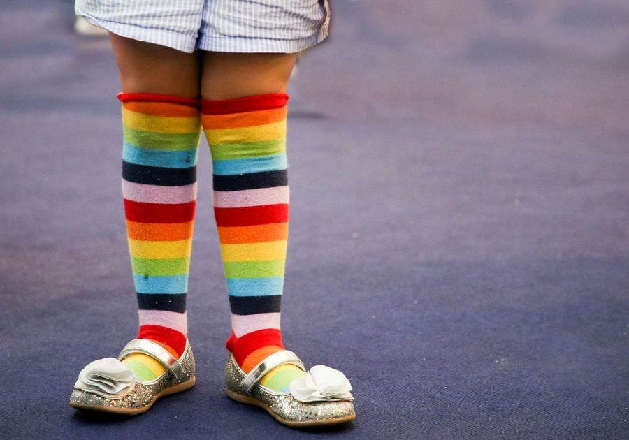 Rainbow socks on little kid legs