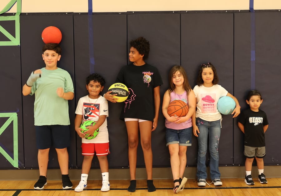 Kids standing in a gym