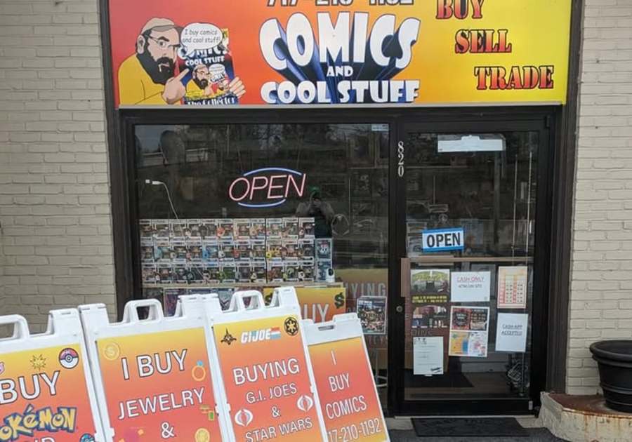 The storefront of Comics and Cool Stuff, a local comic and collectibles shop in Carlisle, PA.  Signs in front advertise the buying and selling of Pokémon cards, jewelry, comics, and vintage toys.