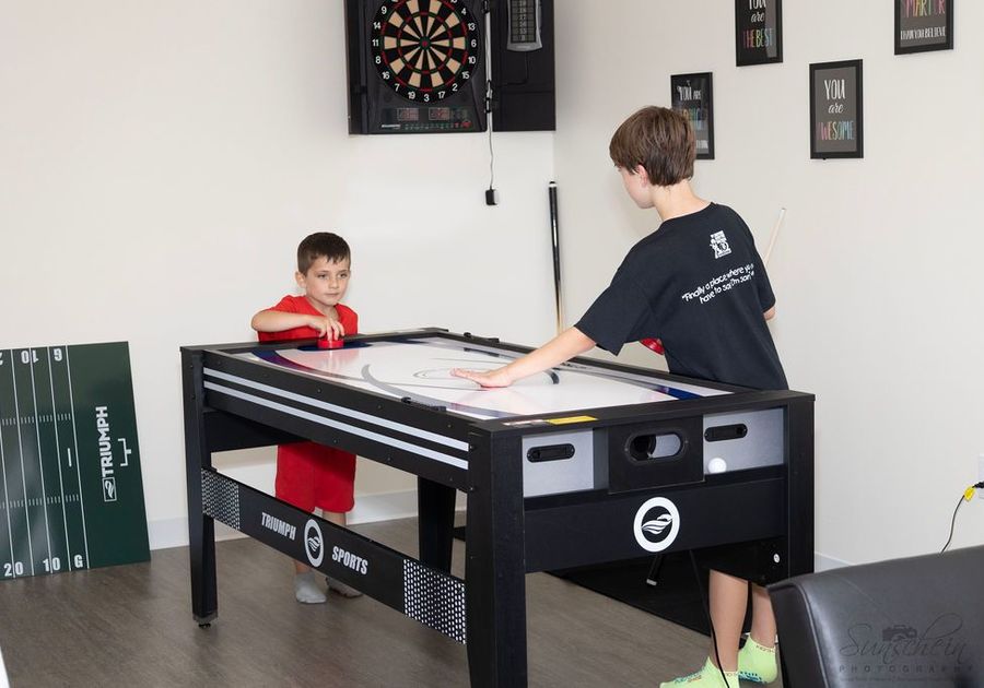 Children playing air hockey