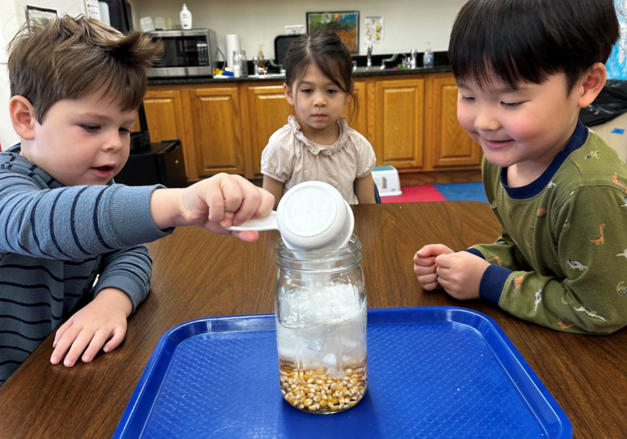 three preschoolers doing a science experiment