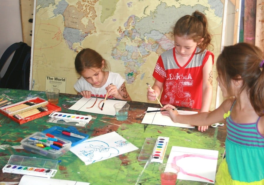 photo of 3 female campers working in art projects